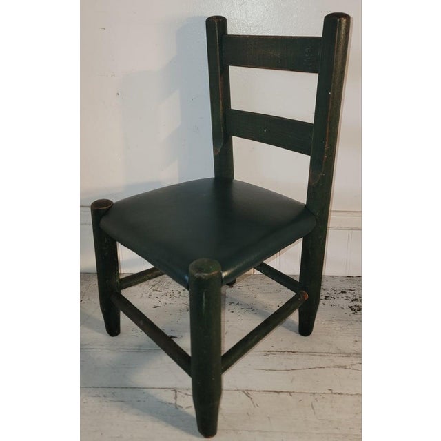 19thc Child's chair is painted in original green with a green leather seat cushion.The condition is very good.