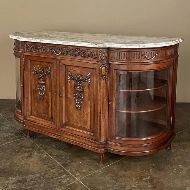 19th Century Louis XVI Marble Top Walnut Display Buffet by Kint of Gand is a stunning piece that will immediately command...