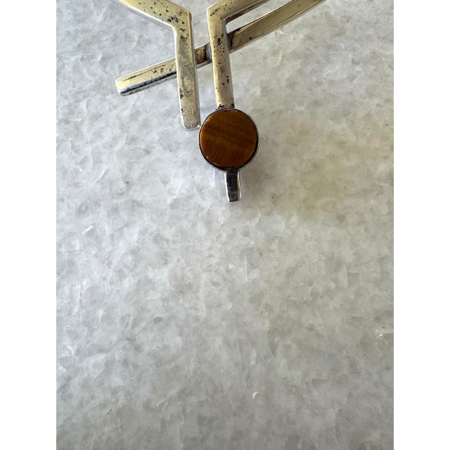 Antonio Pineda Sterling Silver. The Centerstone is Tiger’s eye and on the reverse is onyx. The stone pendant spins to...