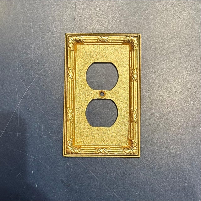 Set of 32 Sherle Wagner Ribbon and Reed Double Duplex Plug Plates. Burnished Gold Finish.