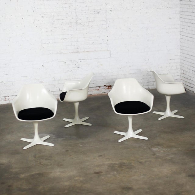 Awesome Mid-20th Century Mid Century Modern Tulip chairs by Burke comprised of a white fiberglass armed shell or frame,...