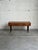 This elegant low-profile Entry Table features a long rectangular top elevated by beautiful tapered legs. Three side-by-...