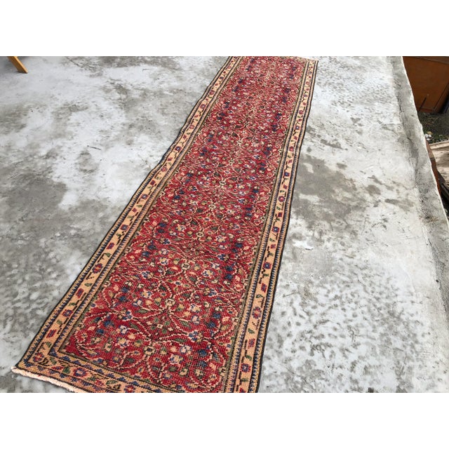 This is a vintage Turkish Oushak rug from the 1960s. The piece was hand-knotted.