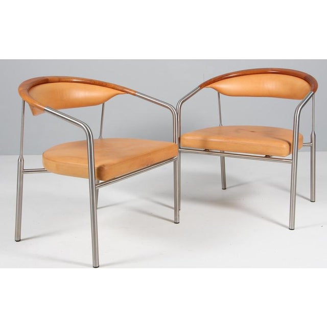 Henrik Tengler lounge chairs in steel and backrest of walnut. Upholstered with patinated nature leather. Made by Hansen &...
