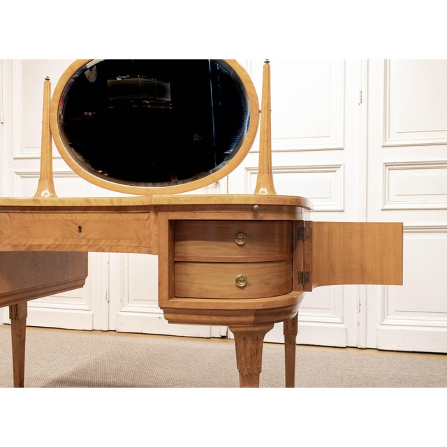 1960s dressing table with mirror, executed in a refined neoclassical style. The piece features beautifully figured book-...
