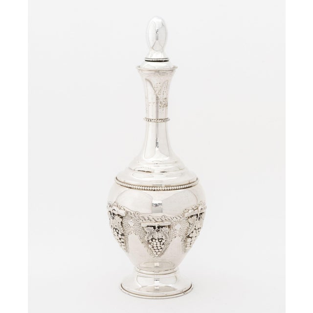 Judaica Sterling Silver Decanter and Kiddush Cup, with repousse grapevine motif, the decanter marked "Sterling" to base...