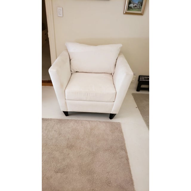 White classic deep armchair. It has a micro suede fabric that can be easily cleaned and the seat and back cushion can be...