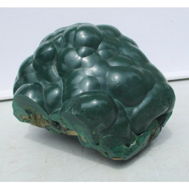 A fine specimen of Malachite crystal cluster in natural form. Bubbling outer surface with glimse into the inner core from...
