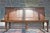 A large historical bench made of solid oak wood, dating from the 19th century. The high backrest is divided into four...