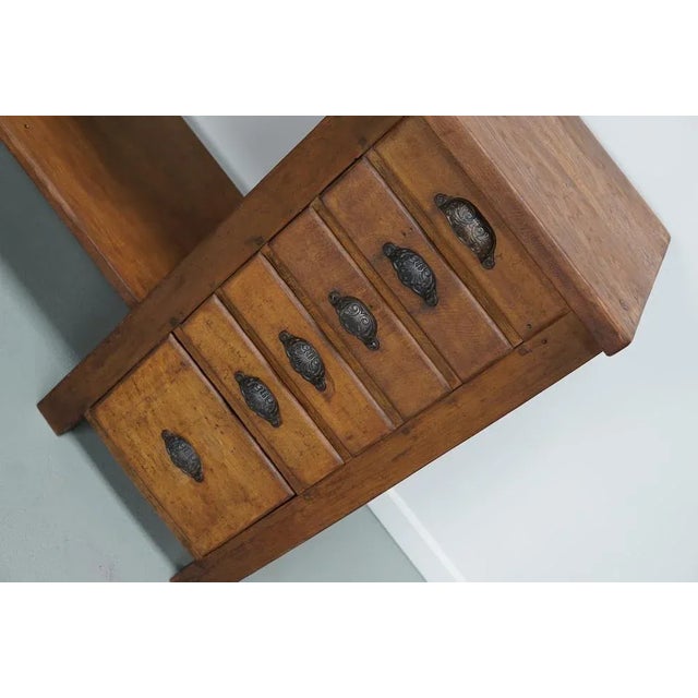 This workbench was made from oak and beech in France. It was either used by a watchmaker or jeweler. It is in a good...