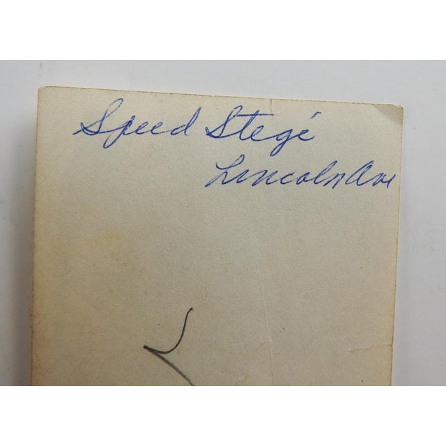 Early 20th century snapshot photograph of young man in cap and sweater. Note on verso Speed Stege, Lincoln Ave. Unframed,...