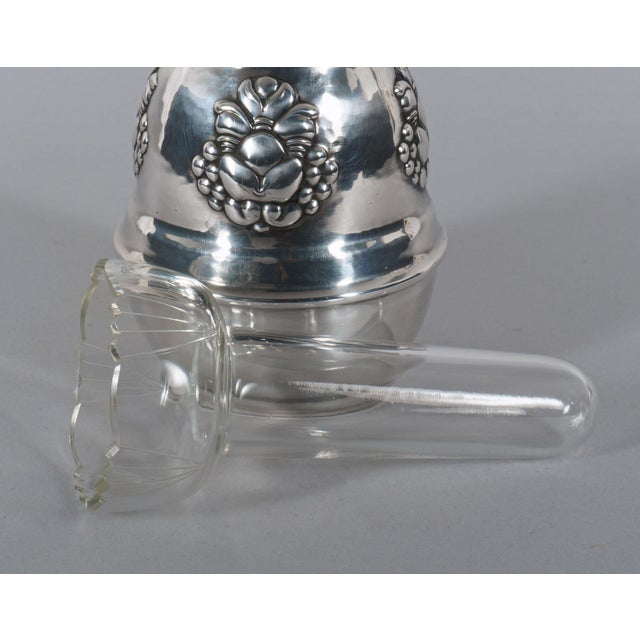 An epns vase in the understated manner of danish art nouveau, with a stepped/ribbed neck and a body decorated with a...