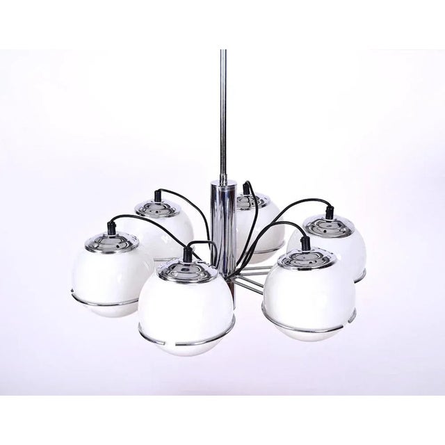 Chrome and opal glass chandelier designed by Sankey Targetti in the 70s. The white opal glass globes seem to float in the...
