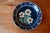 This glazed earthenware dish is a typical example of Soufflenheim pottery. A central bouquet is surrounded by stylized...