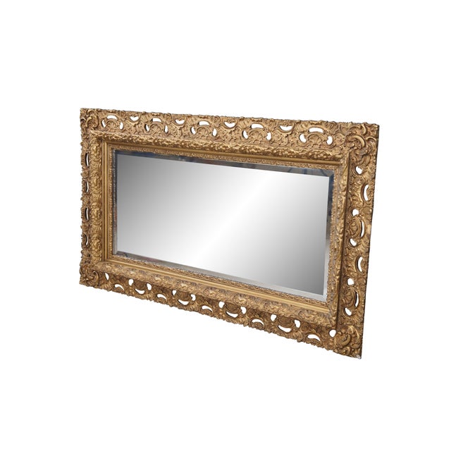 Antique ornate French Baroque / Rococo style gold gilt beveled vanity / hall / mantel mirror featuring a pierced and...