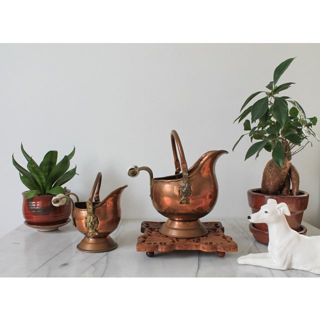 Pair of vintage copper & brass scuttle coal bucket planters with lion head motif and blue and white floral porcelain...