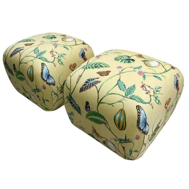 Newly upholstered in Thibaut’s “Lillian” fabric, this vibrant pair of ottomans features a lively botanical and butterfly...