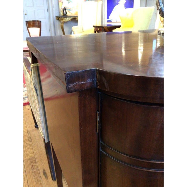 A handsome and finely proportioned 19th-century Georgian style mahogany sideboard of serpentine form, raised on elegant...