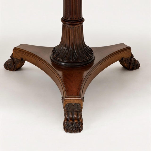 This is a Maitland-Smith neo-classical style inlaid mahogany round dining or center table. It is a mix of veneers to...