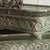 Two-piece set of handcrafted metal planters with a continuous relief decoration, openwork gallery rim, and artificially...
