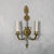 Beautiful pair of brass sconces in the manner of Andre Arbus. Central arrow with a starburst visage, sweeping arms meeting...