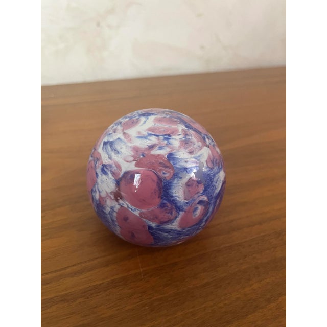 Glass paperweight or sulphide. Its vibrant composition of intertwined blue and pink patterns makes it a small work of art,...