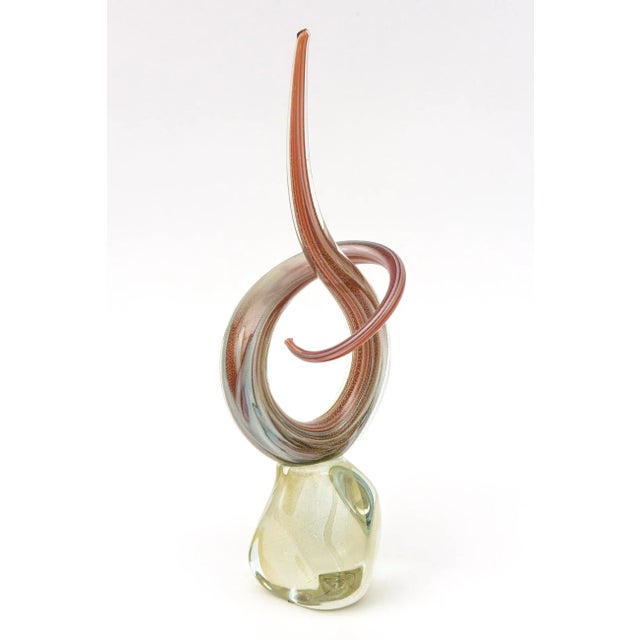 This lovely tall vintage Murano glass sculpture is a twisted swirl of a knot of glass. The colors are shades or orange, to...