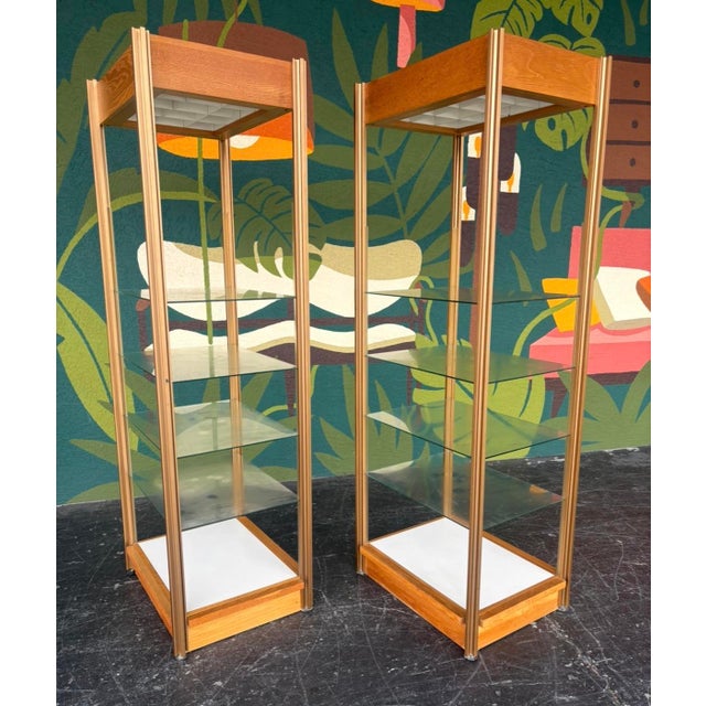 Postmod etagere pair comprised of oak veneers, metal frame, and glass shelves. Perfect pair to flank a sideboard or be...