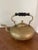 Beautiful antique brass kettle with wooden handle and four feet.