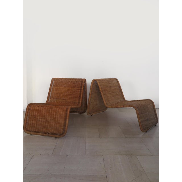 A pair of "Hestra" armchairs manufactured by IKEA in the 1980s, with an iron frame and rattan upholstery; made in Sweden...