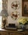 A charming pair of early 20th century Chinoiserie decorative wall plates, each painted with lush red blossoms, trailing...