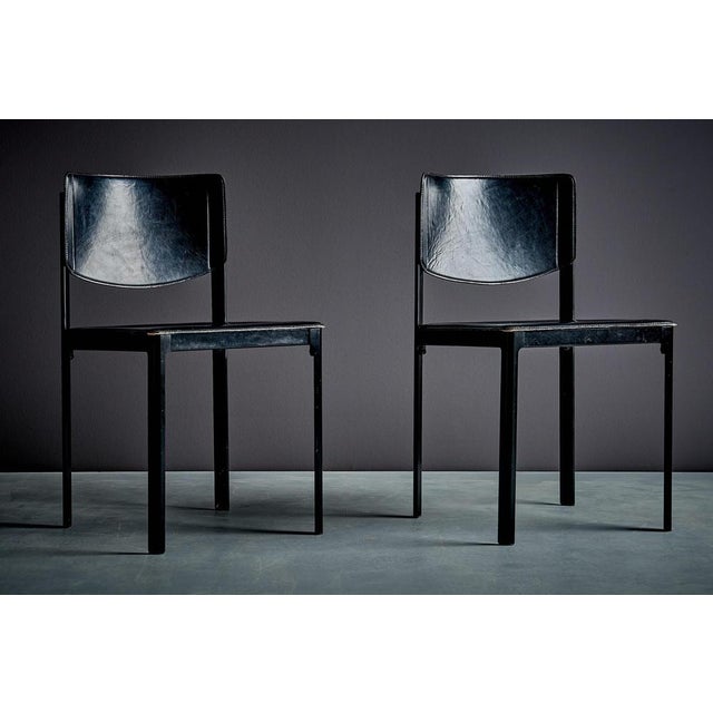 A refined pair of chairs defined by clean lines, a lightly curved backrest, and a restrained, architectural silhouette....