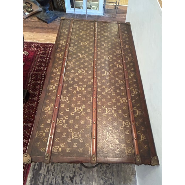 Stunning large leather wrapped trunk having handsome wood mounts with nail heads, leather handles and bronze patina...