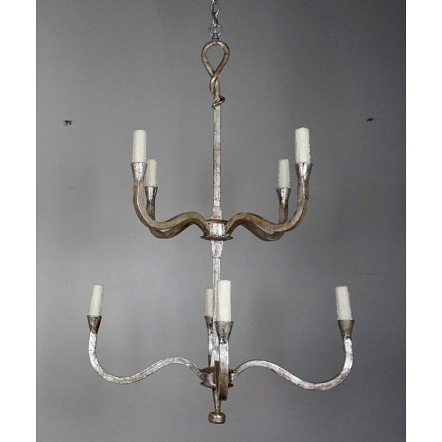 Wrought Iron silver gilt wrought i two-tier chandeliers. Each chandelier has eight candleholders with drip wax candle...