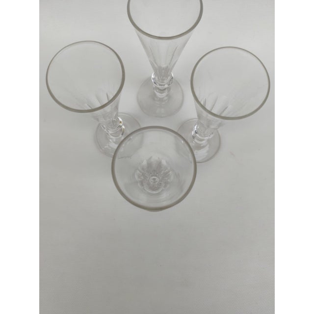 Four 19th-Century Glass Champagne Flutes. Flat-ribbed design. Very elegant and delicate. Wide stem. Height 17.8 cm. Top...