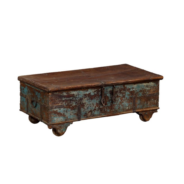 Antique Indian Painted Teakwood Chest/Coffee Table, late 19th century from Rajasthan. On wooden wheels, with old teal...