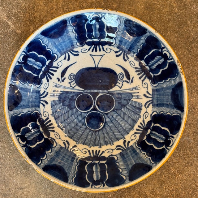 An 18th century Delft charger hand-decorated in bold cobalt blue with a variation of the “Peacock” pattern. This version...
