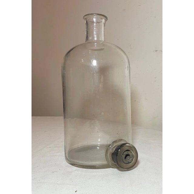Up for sale is a very rare antique 19th century clear glass chemistry bottle with drain. This lovely bottle is blown out...
