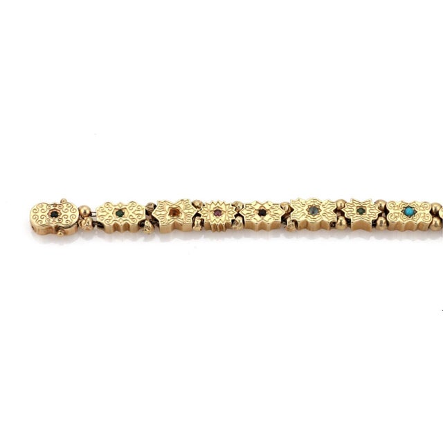This is a lovely vintage slide bracelet, it is crafted from 14k yellow gold with a polished finish. It has 13 floral slide...