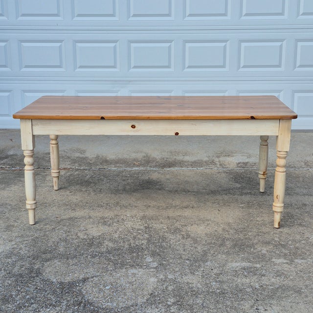 This is a French country farmhouse style pine dining table by high-end American furniture maker Ethan Allen. The...