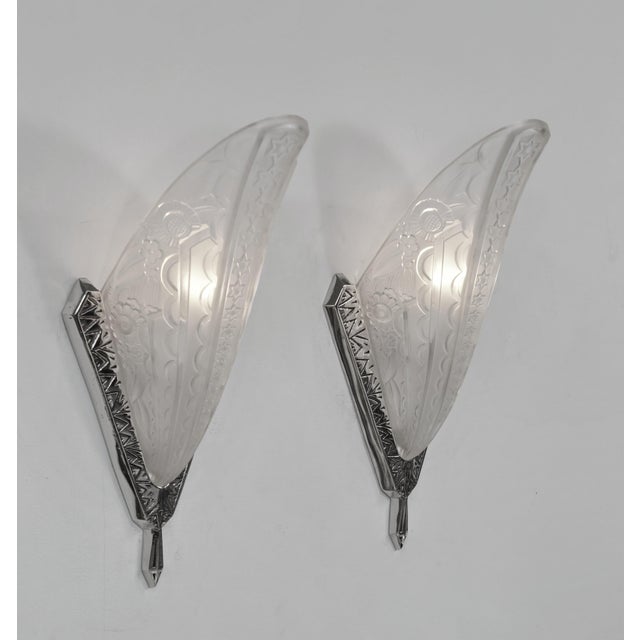 Donna Paris A beautiful pair of 1925-1930 French art deco wall sconces in nickel on cast solid brass holding shades in...
