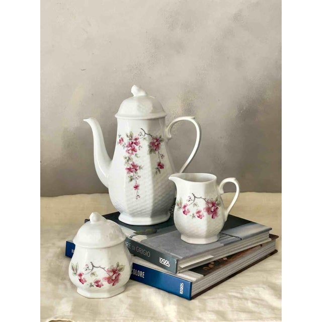 An elegant vintage coffee set consisting of a coffee pot, milk jug, and sugar bowl, crafted by the prestigious German...