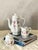 An elegant vintage coffee set consisting of a coffee pot, milk jug, and sugar bowl, crafted by the prestigious German...