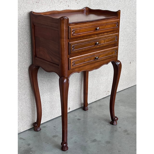 A pair of Antique French Louis XV Marquetry light oak top nightstands. Subtle contours and scroll shapes are evident in...