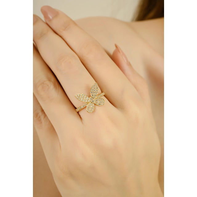 This ring is crafted in 14K yellow gold, designed in a butterfly motif. It features round cut diamonds, totaling 0.58...