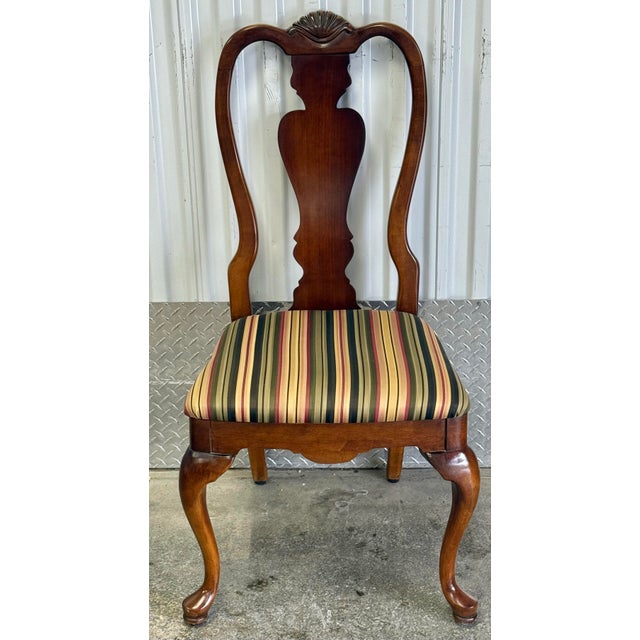 A set of 6 traditional, solid cherry, Queen Anne style dining chairs with carved back slat, cabriole legs and pad feet....