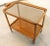 Beautiful, very beautifully designed bar cart made of warm-colored wood with handy wheels and a beautiful smoked glass...