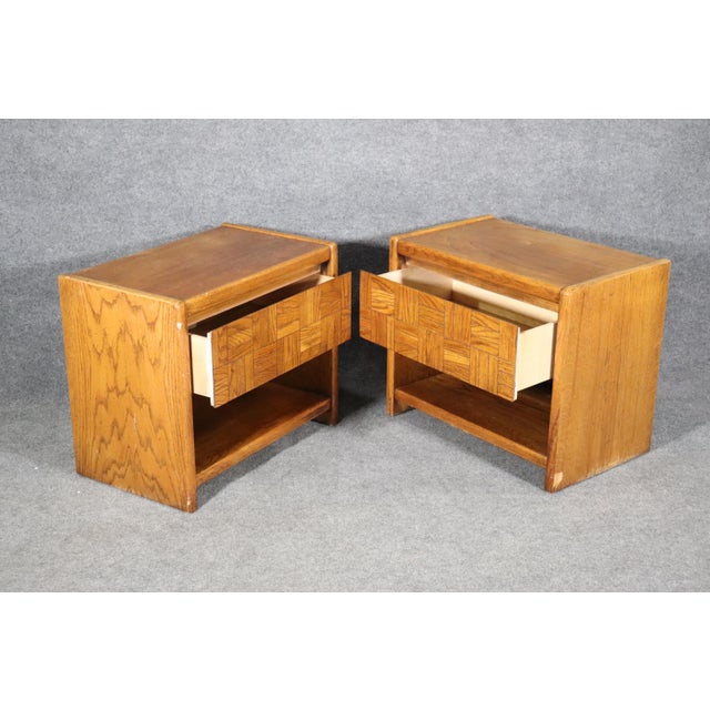 Pair of mid-century end tables by Lane Furniture. Oak wood grain with tile motif drawers. Not marked