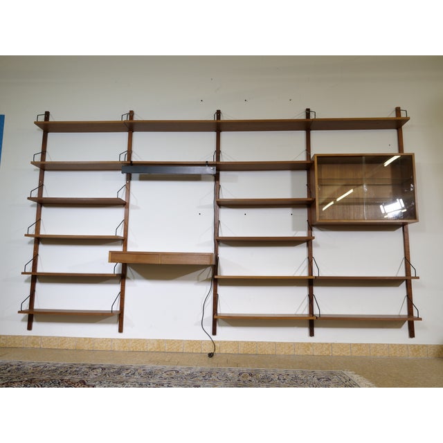Modular mid-century "Royal" shelving system in teak by Poul Cadovius, 1960s. Wall-mounted construction with five...