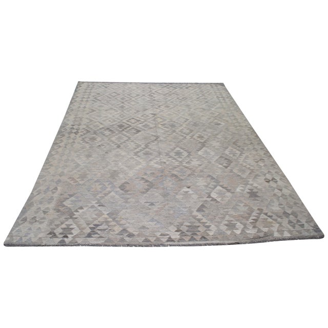 Hand-knotted with care using traditional rug-making techniques, this wool rug blends timeless craftsmanship with a modern...